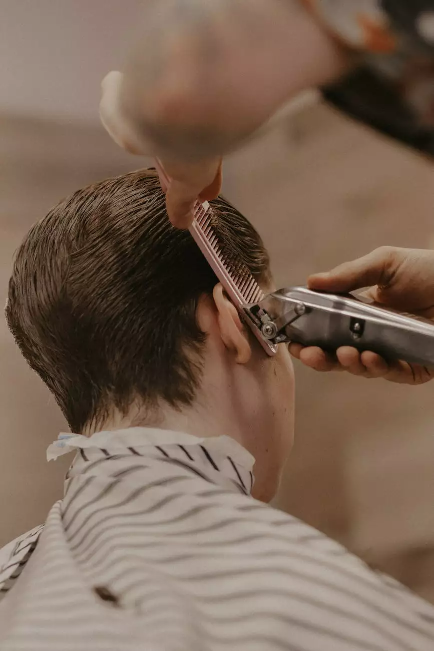 Clipper and comb used to shape the side of a haircut